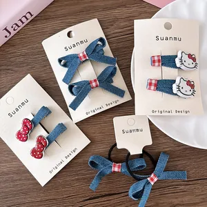 Detail of Hello Kitty denim bow hair clips and ties set on a display card