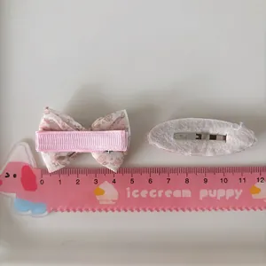 Pink floral bow hair clips for girls featuring fabric wrapped bb clips and size ruler