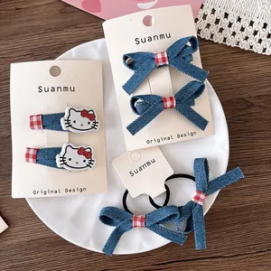 Detail of Hello Kitty denim bow hair clip set and ties for girls in a ceramic plate