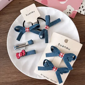 Detailed set of blue denim and red polka dot bow hair clips and ties on display