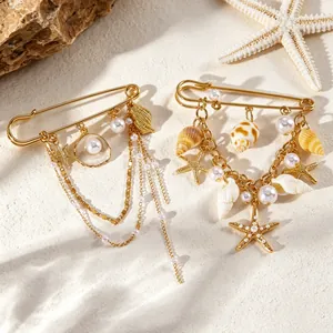 Détail de broches en forme d'étoile de mer et de coquillage avec perles d'imitation