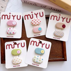 Detail of sweet handmade fabric hair clips set with polka dots and checkered patterns