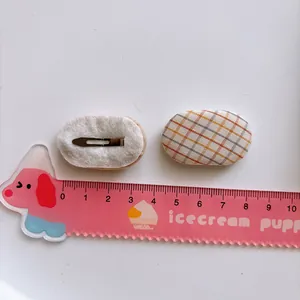 Pair of sweet yellow orange plaid oval BB hair clips for kids shown with scale ruler
