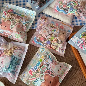 Bulk set of colorful children's hair ties in a cute macaron style storage bag