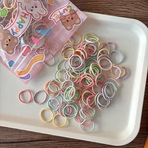 Detail of colorful macaron elastic hair bands in a cute rabbit bear patterned pouch