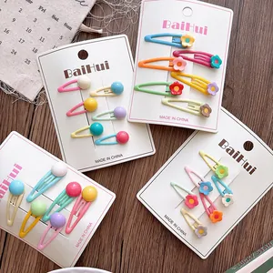 Detail showing macaron color flower and candy ball BB clips on display cards