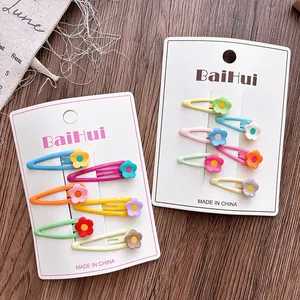 Detail of colorful macaron flower hair clips for girls set on white display card