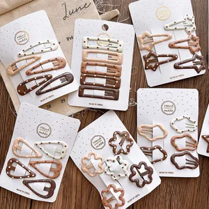 Detailed set of assorted brown and beige polka dot hair clips for girls on display cards