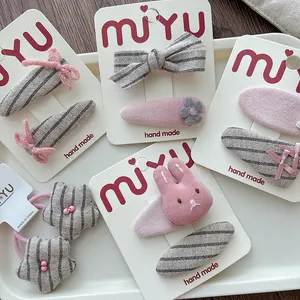 Pink and grey striped fabric hair clips set with handmade bows and rabbit detail
