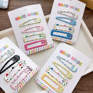 Detailed close-up of 5cm girls hair clips set with colorful patterns on display cards