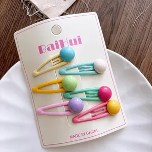 Detailed set of 6 candy-colored BB hair clips with glossy spherical charms on display