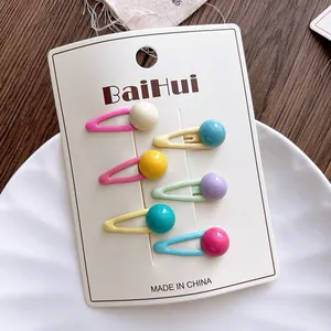 Close-up of six colorful candy-bead drip oil hair clips on a white display card