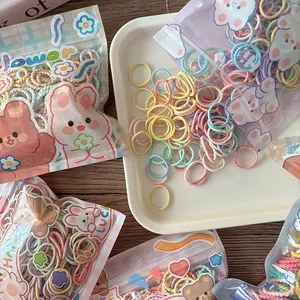 Close-up of colorful elastic hair bands in a cute cartoon frosted zipper storage bag