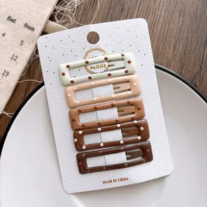 Five-piece gradient coffee brown polka dot hair clips set on a display card