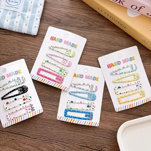 5cm colorful polka dot and striped girls' snap hair clips set on wooden surface