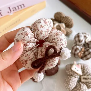 Floral plaid scrunchie with brown bow and plush balls for girls sweet autumn hair style