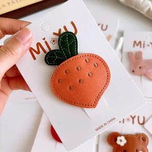 Cute carrot-shaped faux leather hair clip for girls with stitched details on card