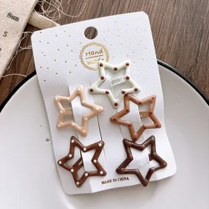 Detail of five star-shaped polka dot clips in coffee gradient colors on display card