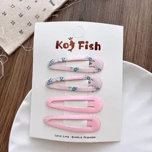 Set van vier pastelroze metalen BB-haarclips met bloemen- en konijnenprints op displaykaart