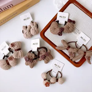 Detail of plush brown bow hair ties and cute animal hair accessories for girls