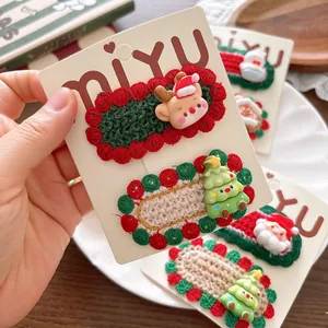 Knitted Christmas hair clips with reindeer, Santa, and tree designs for girls