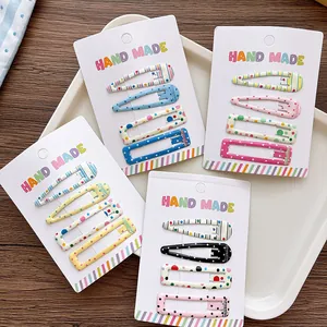 Detail of 4-piece colorful floral pattern hair clips set on handmade display card