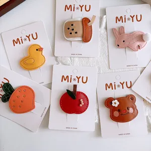 Detail of leather hair clips set featuring cute cartoon animals and fruit shapes