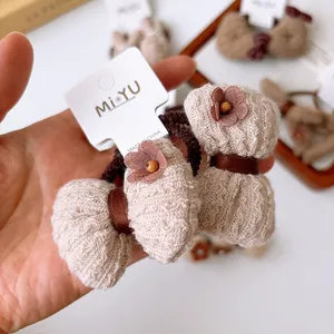 Set of two brown knit bow hair ties for girls with floral and wood bead accents