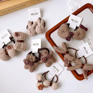 Detail of brown and beige kids hair ties with rabbit, bear, and bow designs on cards