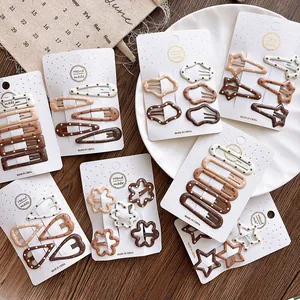 Close-up of matte coffee gradient polka dot hair clips in various geometric shapes