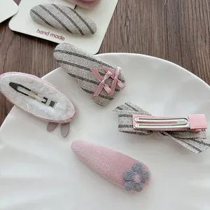 Pink and grey fabric bow hair clips for girls featuring stripes and bunny floral patterns