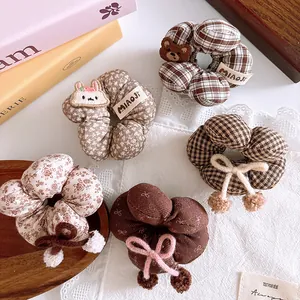 Detailed set of brown plaid scrunchies with cute bear and rabbit embroidery
