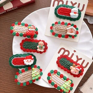 Detailed view of handmade crochet Christmas hair clips with festive resin charms and ornaments