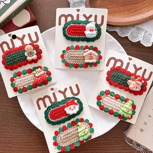 Detailed view of hand-knitted Christmas hair clips with Santa and reindeer motifs