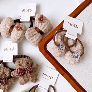 Plush brown children's hair ties set featuring cute teddy bear and bunny ear designs