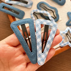 Set of minimalist blue denim and plaid hair clips in triangle and star shapes