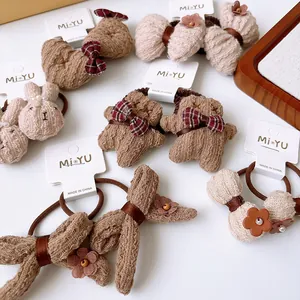 Detail of plush brown hair ties featuring cute bears, rabbits and bow-knots for girls