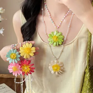Close-up of colorful daisy beaded necklaces in vibrant spring-inspired colors.