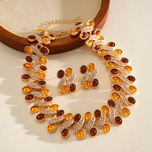Detail of retro palace style resin necklace and earrings with amber stones