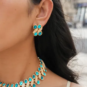 Detail view of vintage turquoise resin and rhinestone necklace and earring jewelry set