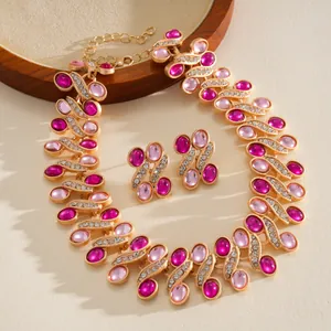 Detail of vintage palace style necklace with pink resin stones and rhinestones.