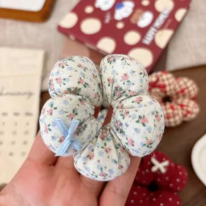 Floral fabric hair scrunchie with light blue ribbon bow for girls hair styling