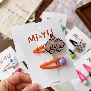 Embroidered cartoon puppy and purple bead hair clip set for girls on a display card