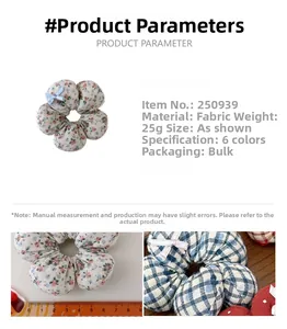 Close-up of floral fabric scrunchie with polka dots, ribbons, and measurement scale