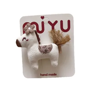 Cute handmade knitted pony hair clip for girls with flower detail on white card