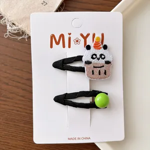 Detail of embroidered panda cupcake BB hair clip and green bead hair clip for girls