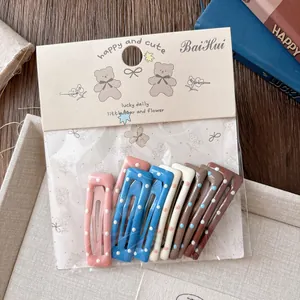 Détail de 10 barrettes BB à pois aux couleurs douces d'hiver avec emballage cartonné