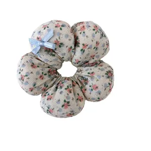 Floral print fabric flower hair scrunchie with a blue bow for girls hair styling