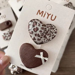 Chic leopard print and brown satin heart hair clips set on a display card