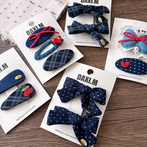 Detail of Korean style navy plaid and polka dot bow hair clips on display cards